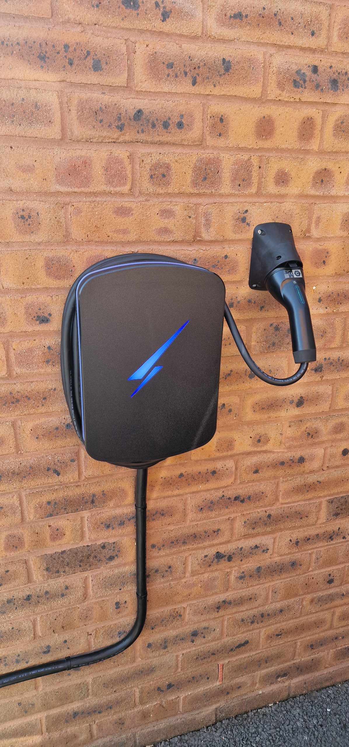 Car charging point on the wall of a house